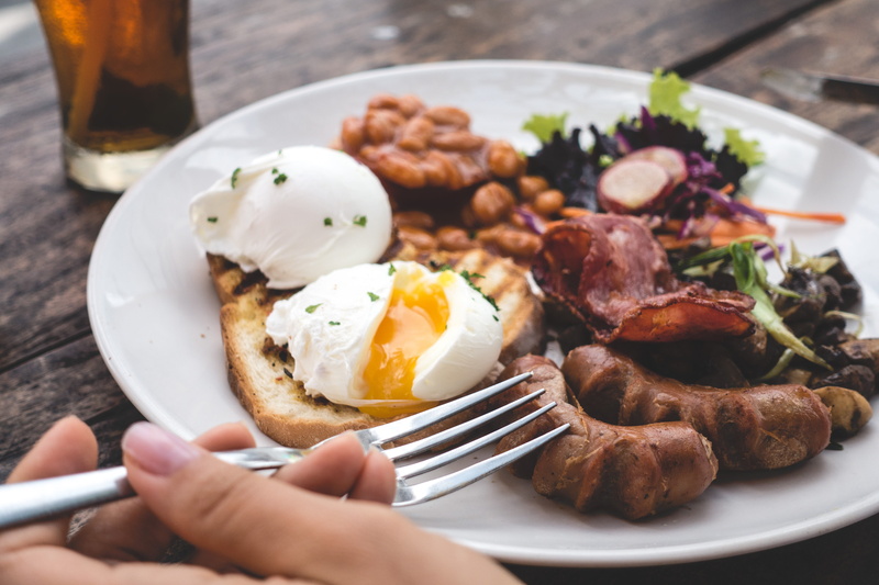 café, meat, close up, food, egg, hand, sausage, human hand, healthy, bacon, breakfast, sunny side up, one person, paleo, poached, poached eggs, close-up