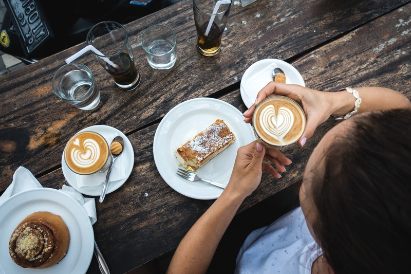 kitchen utensil, frothy drink, relax, high angle view, drink, glass, cafe, saucer, coffee cup, cappuccino, wood, plate, food, sweet, mug, human hand, food and drink