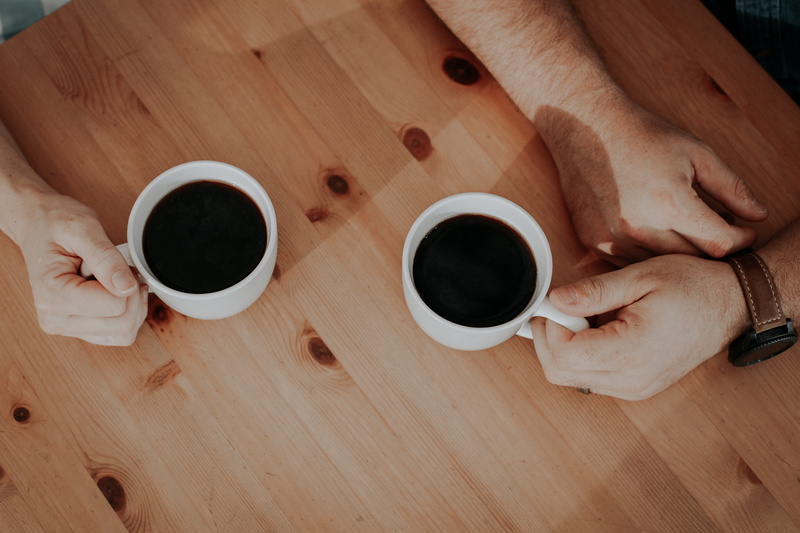 indoors, high angle view, human hand, directly above, couple, wood - material, caucasian, couple - relationship, filled, surface, people, two, person, drink