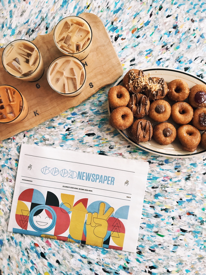 newspaper, ice, newsprint, freshness, coffee shop, pastry, oval, coffee, still life, text, book, iced, food, board, cookie, chai, pips original doughnuts and chai