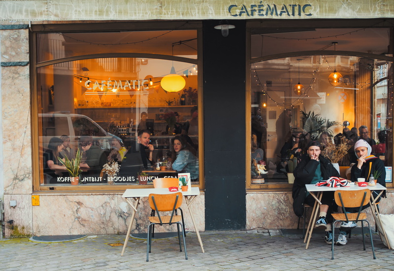 group of people, dining, table, sitting, adult, business, seat, restaurant, people, cafe, building exterior, crowd, street, city, food and drink, transparent