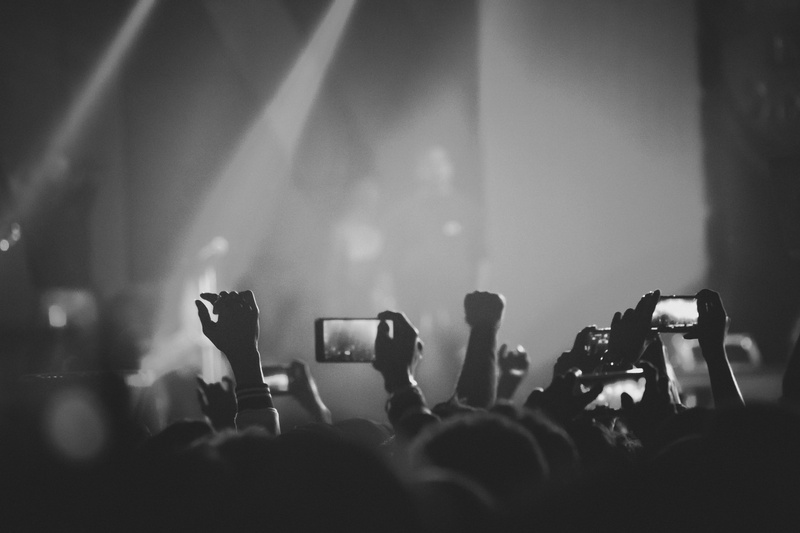 filming, nightlife, lights, wireless technology, holding, stage, black and white, popular music concert, positive emotion, crowd, camera - photographic equipment