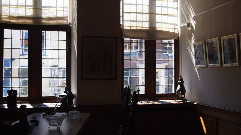 shelf, education, painting, glass windows, ornaments, book, floor, people, interior design, table, publication, indoors, architecture, furniture, day, nature