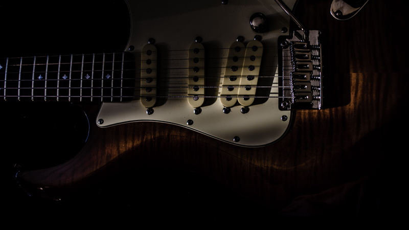  no people, musical equipment, guitar, string, electrical equipment, close-up, sunlight, studio shot, music, string instrument, dark, spotlight