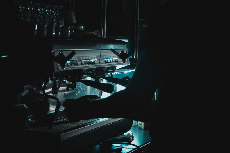 coffee machine, equipment, technology, men, mode of transportation, transportation, control room, real people, vehicle interior, bar, dark, control, indoors