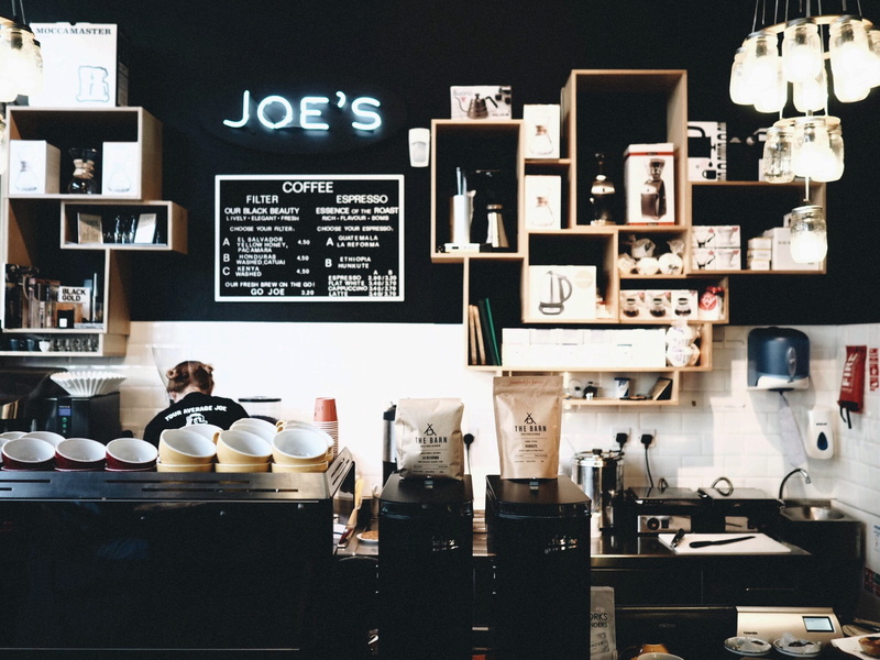 choice, communication, woman, arrangement, coffee shop, indoors, machine, container, technology, cup, table, cafe, shelf, large group of objects, business