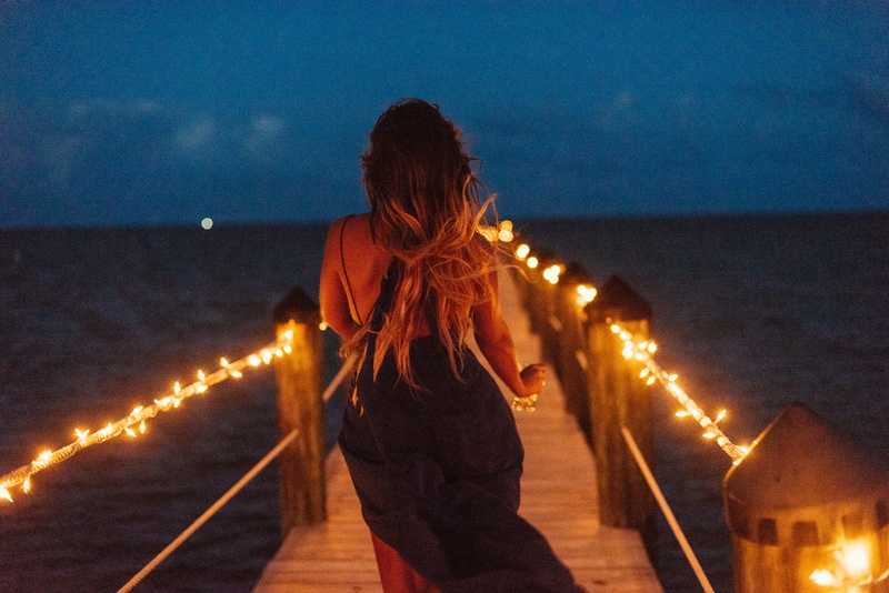 horizon over water, real people, three quarter length, sky, luces, illuminated, lifestyles, women, fun, outdoors, sea, water, rear view, nature, united states