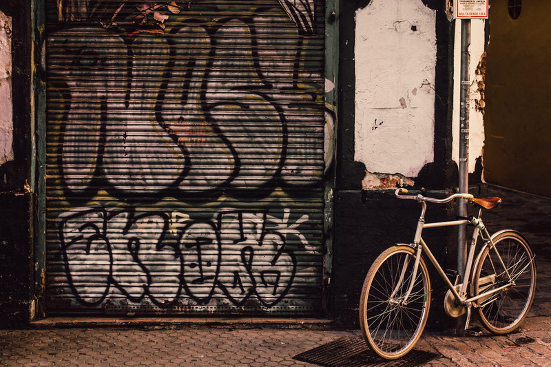building exterior, built structure, wall, painting, bike, creativity, art and craft, roll-up door, wall - building feature, brick, day, entrance, graffiti