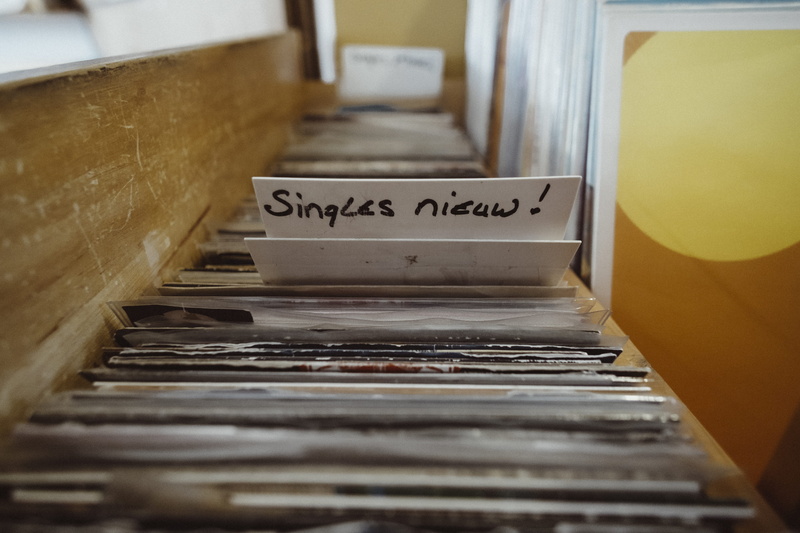 container, velvet music, vintage, western script, vinyl, new, selective focus, text, no people, business, close-up, food, records, paper, store, retail