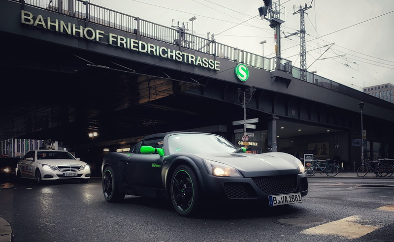 communication, car, machine, western script, sign, bike, light, day, berlin, no people, transportation, spoke, urban, 2K, black, connection, motor vehicle