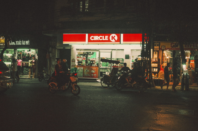 circle, people, street, mode of transportation, illuminated, signage, road, architecture, incidental people, men, building exterior, stores, communication