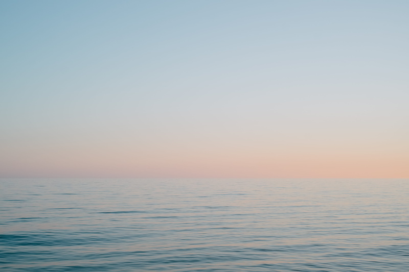 clothing, beauty in nature, idyllic, daytime, clear sky, rippled, horizon, water, vehicle, sun, sunset, waterfront, sunrise, outdoors, nature, red sky