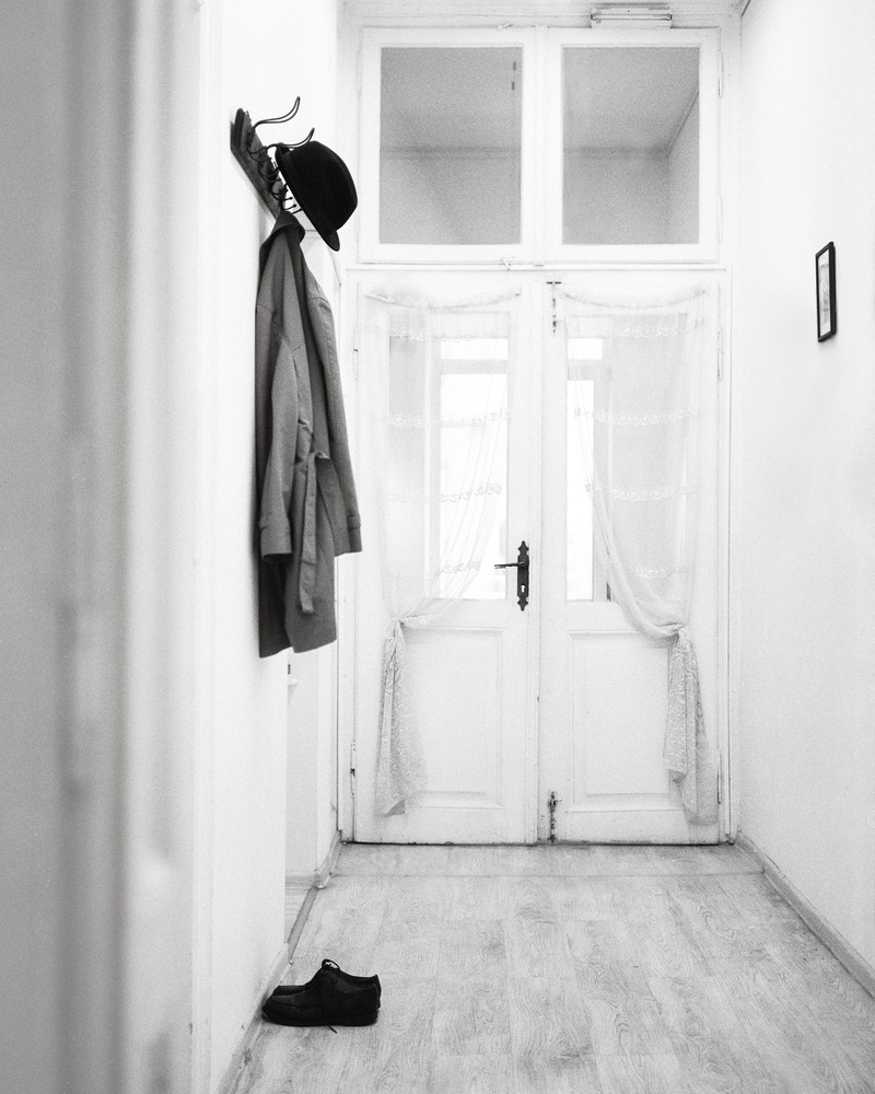 domestic room, door, shoe, architecture, doorway, wall - building feature, one person, photography, black and white, coat, built structure, window, 4K