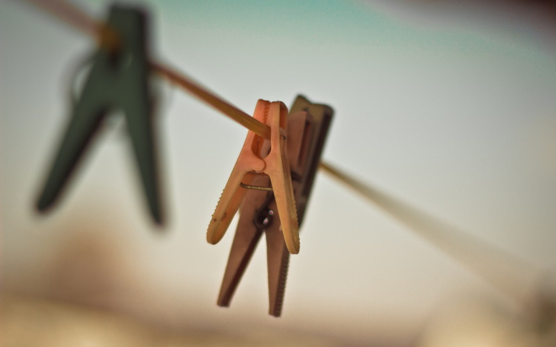 hanging, metal, close-up, low angle view, wall - building feature, music, wood - material, absence, coathanger, in a row, two objects, artistic, no people
