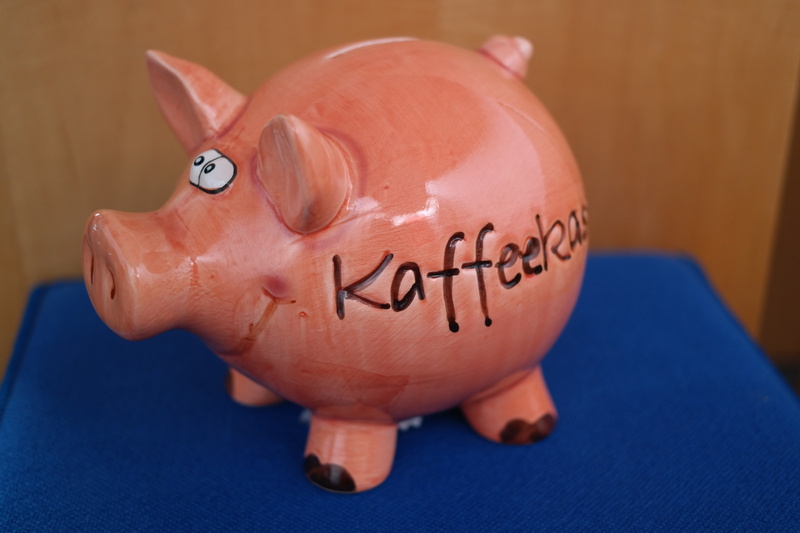 close-up, coffee checkout, business, humor, porcelain figurine, donate, focus on foreground, animal, pig, investment, cheerful, funny, revenue, checkout