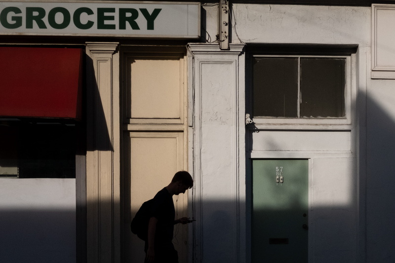 city, silhouette, street view, man, holding, red, grocery, streetphotography, urban Scene, editorial, male, door, street, shadows, people, sign, smartphone