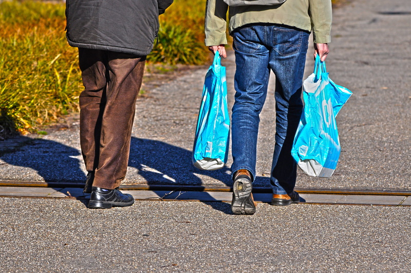 man, sunlight, city, movement, sunny, shadow, outdoor, jeans, men, walking, two people, human body part, hand, adult, road, shoe, shopping bag, carrying