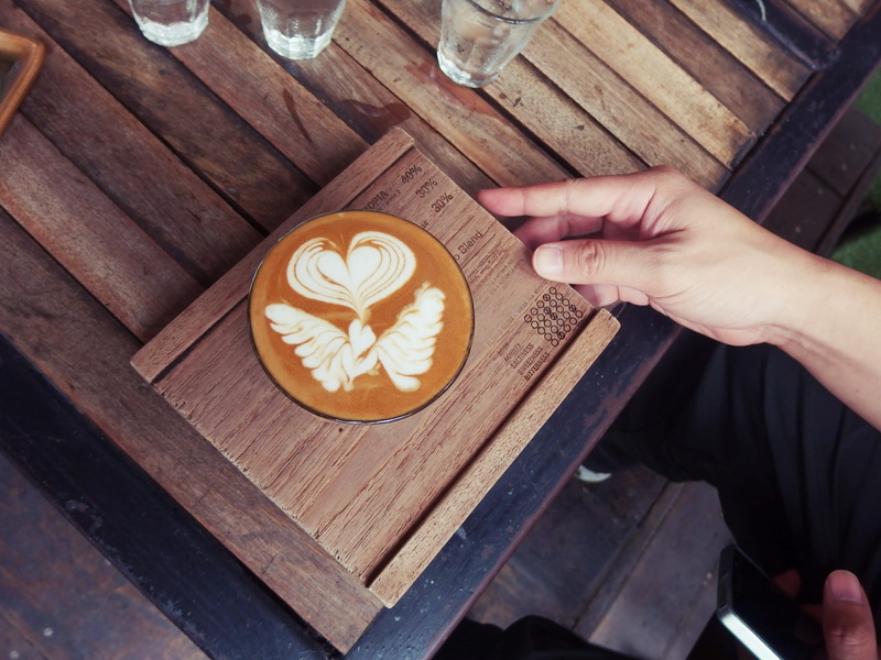 coffee, human hand, coaster, coffee - drink, wood, table, hot drink, wooden, cappucino, latte, coffee table, wood - material, drink, crockery, human body part