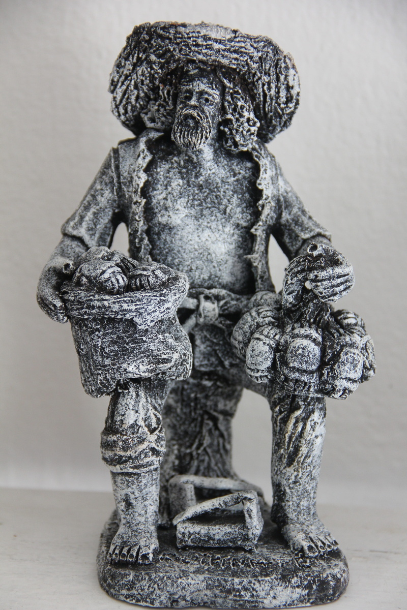 female likeness, indoors, wall - building feature, creativity, carving - craft product, focus on foreground, sculpture, clay, human representation, male likeness