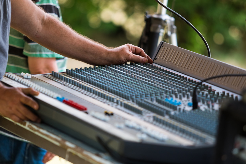 sound recording equipment, focus, push button, photography, adjusting, human body part, one person, producer, console, using, concert, human hand, mixing panel