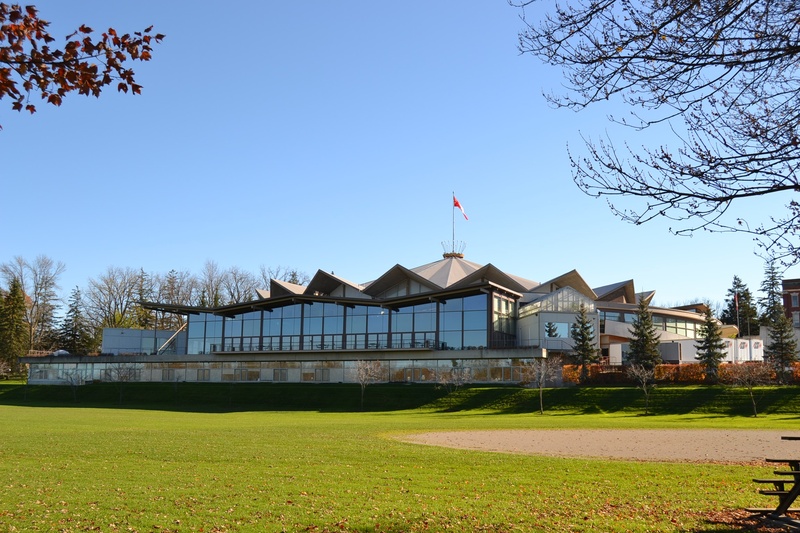 house, sky, growth, stratford, lawn, plant, clear sky, land, theater, day, winter, built structure, building exterior, field, flag, tree, festival, theatre