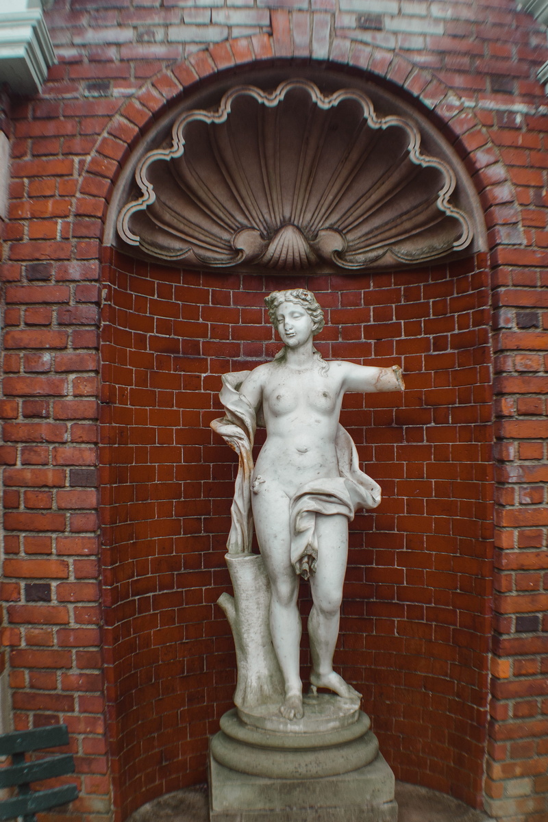 day, religion, sphere, cross, water, art and craft, carving, human representation, banister, wall, art, curtain, sculpture, building exterior, built structure