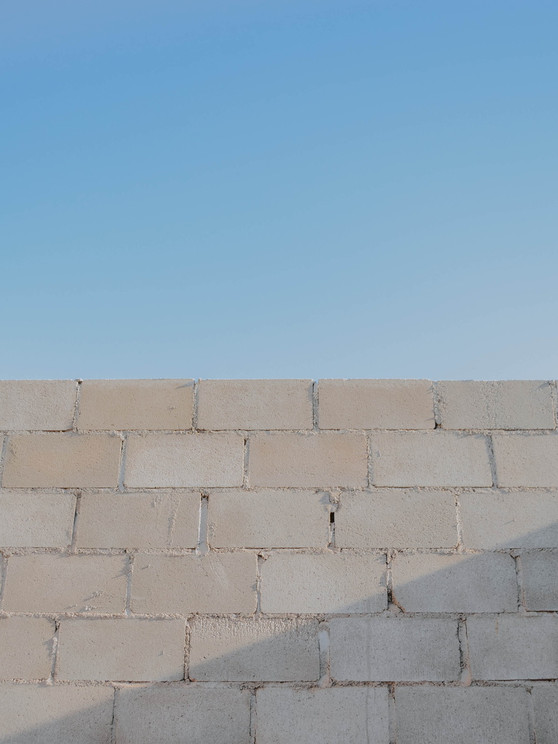 copy space, surrounding wall, built structure, salt flat, nature, plaque, clothing, sky, sunlight, wall - building feature, no people, sidewalk, concrete