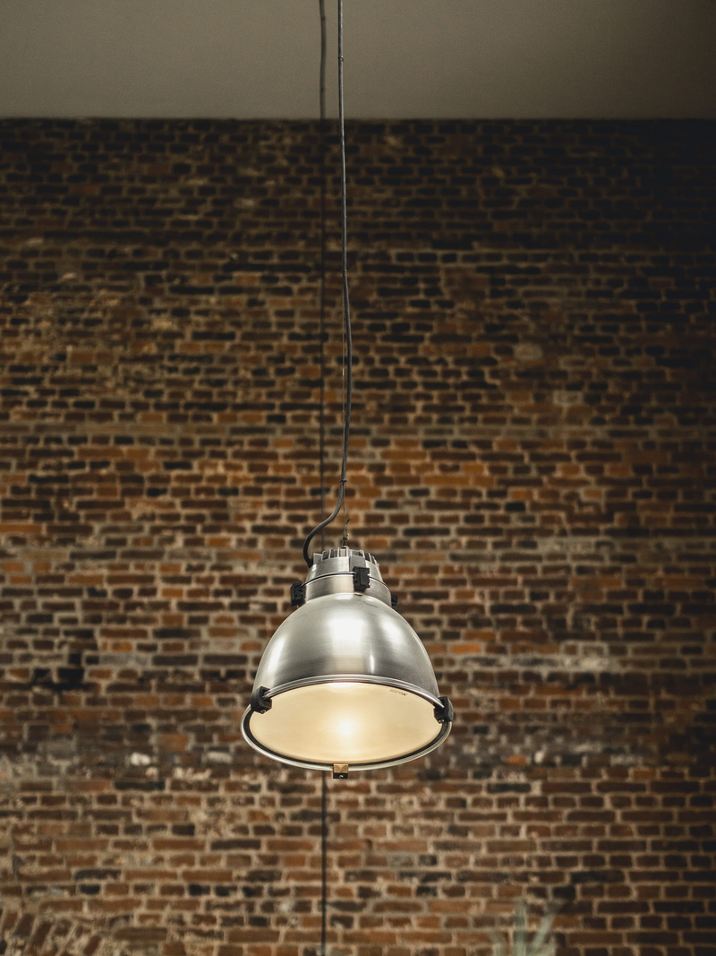 steel, plaque, sidewalk, pavement, planter, hanging, wall - building feature, pendant light, strap, lighting, brick wall, potted plant, lighting equipment