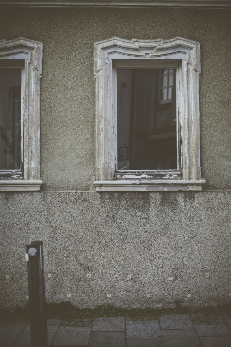 outdoors, building exterior, wall, house, built structure, plaque, texture, military, porthole, daytime, reflection, home decor, wooden, door, officer