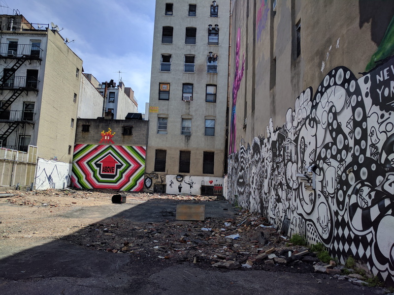 trash, handrail, new york, residential district, direction, dirt road, building exterior, road, day, plaque, painting, multi colored, nature, city, wall - building feature