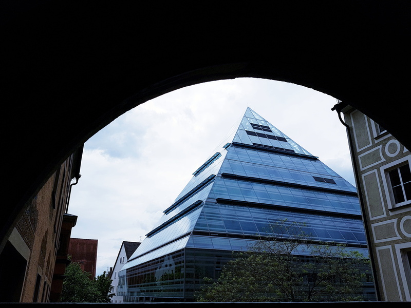 cloud - sky, building, built structure, tall - high, spire, glass - material, no people, day, pyramid, library, arch, city, low angle view, plant, tower