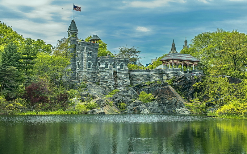 stones, flag, tower, Manhattan, water, castle, Central Park, New York City, USA, lake, rock, trees, city, American flag, clouds, building, people, landscape