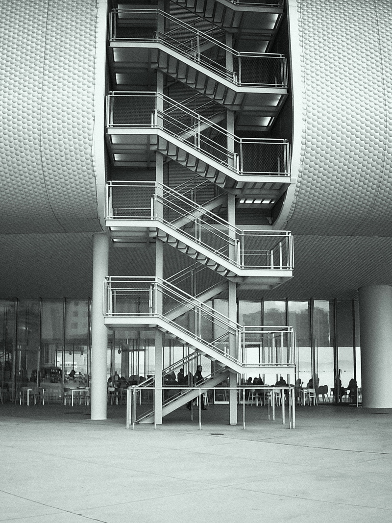 fire escape, renzopiano, building exterior, contemporary architecture, sea, railing, people, art, black and white, modern, ceiling, digifilm, curve, day