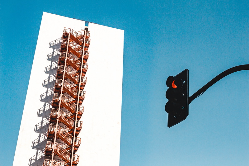 steel, outdoors, sky, light, daylight, traffic light, road signal, clear sky, built structure, sign, shadow, nature, stoplight, blue sky, white, skyscraper