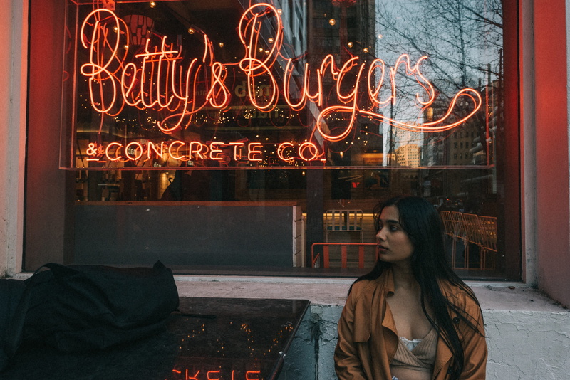 standing, night, front view, woman, communication, lifestyles, betty, near, young adult, s, 5K, casual clothing, burgers, women, illuminated, window, western script