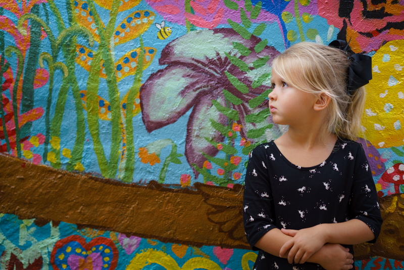 one person, leisure activity, thinking, people, united states, mural, leaning, hairstyle, 8K, innocence, art and craft, child, person, multi colored, daughter