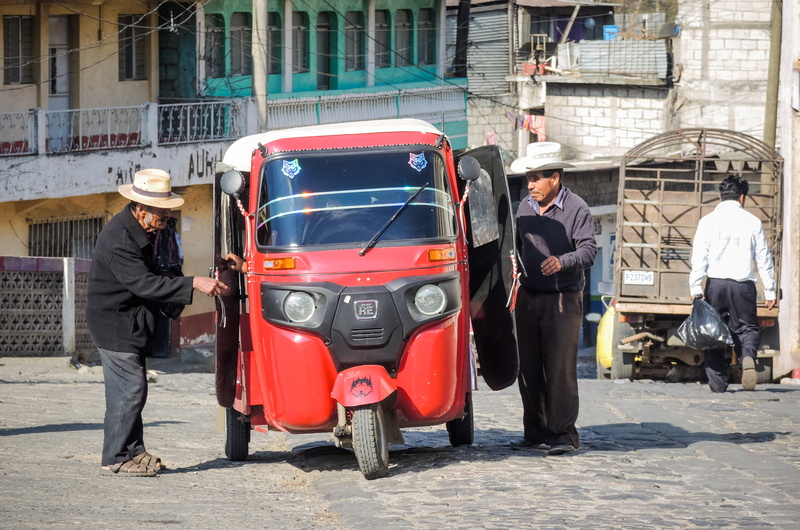 land vehicle, women, day, building exterior, three wheeler, car, tuktuk, transportation, cowboy hat, adult, mode of transportation, incidental people, city