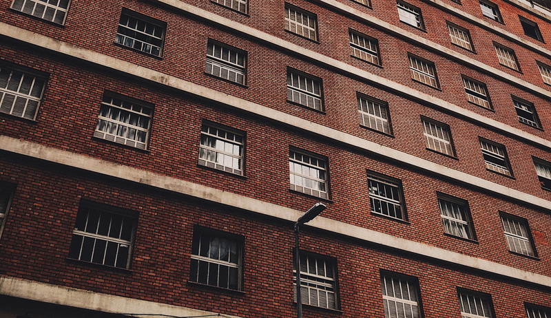 full frame, day, brickwork, background, city, exterior, red brick, outdoors, apartment, streetlight, brick, window, architecture, built structure, repetition