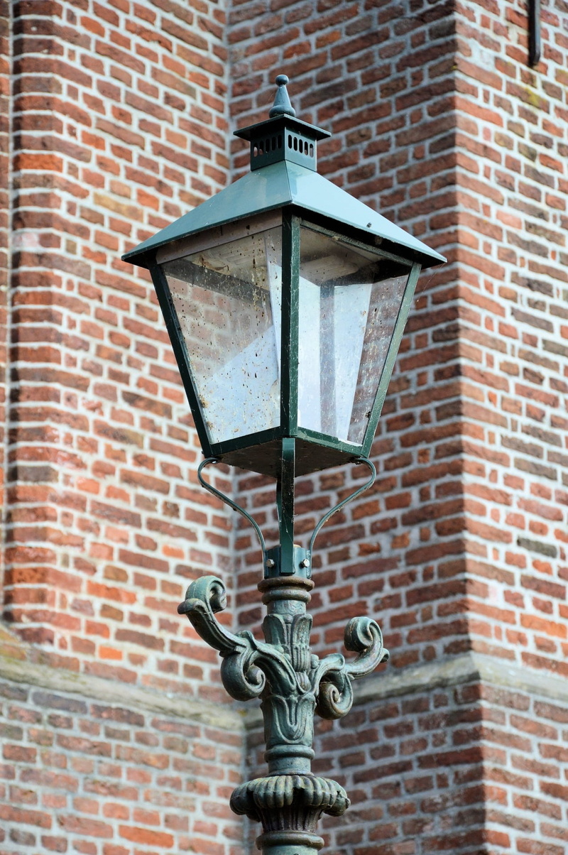 block, no people, street light, masonry, representation, light, art and craft, architecture, day, surface, antique, low angle view, electric, textured