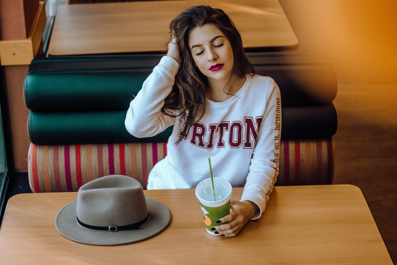 one person, long hair, restaurant, table, holding, food, lipstick, sitting, drink, women, glass, beautiful woman, brazil, soda, indoors, cup, refreshment