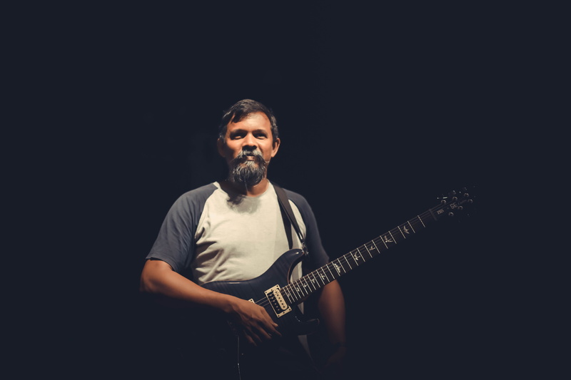 faces, men, 5K, candid, lights, front view, one person, guitar, music, copy space, guitarist, black background, india, males, beard, indoors, skill, artist