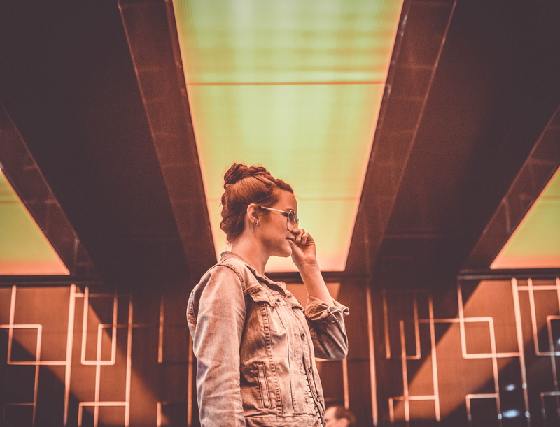 portrait, one person, outdoors, building, glass, standing, metal, denim jacket, orange, 4K, contemplation, grill, room, smart phone, blue, white, telephone