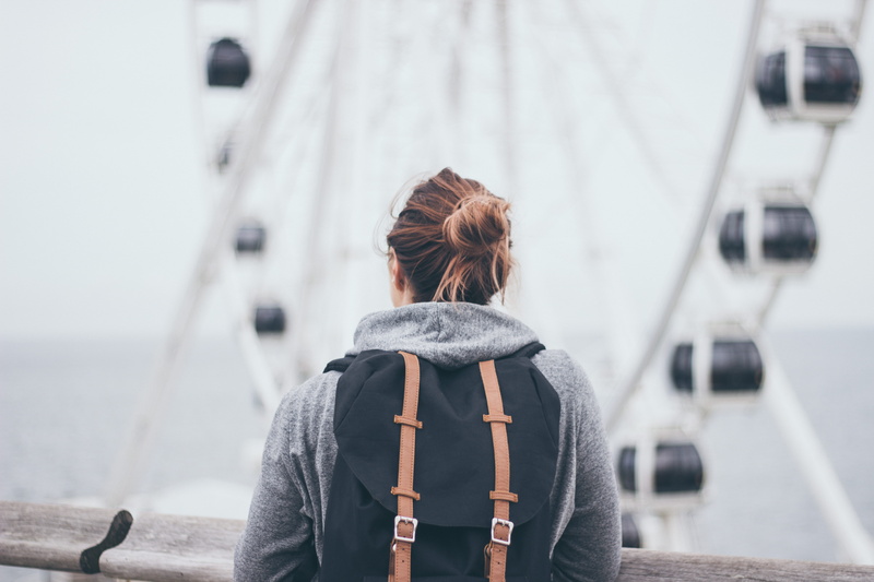 hairstyle, mode of transportation, transportation, day, big wheel, woman, near, one person, female, sea, 5K, waist up, backpack, focus, warm clothing