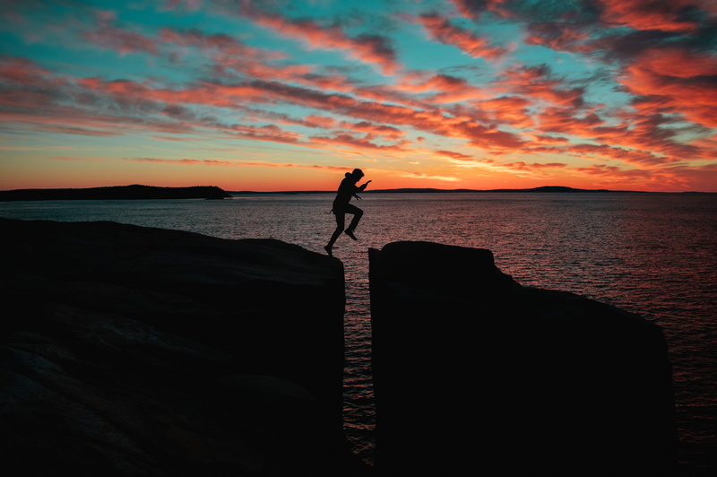 outdoors, water, jump, man, standing, sunset, leap, leisure activity, horizon over water, sky, lifestyles, cloudscape, tranquility, jumps, ocean, orange color