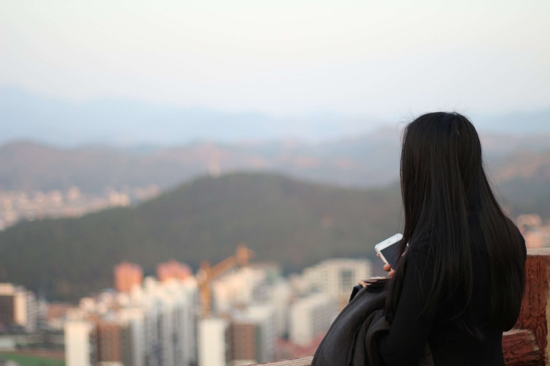 real people, built structure, panorama, focus on foreground, architecture, mountain range, cityscape, lifestyles, headshot, outdoors, woman, hair, royalty