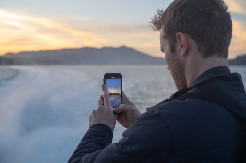 telephone, sunset, mountain, real people, phone, hands, leisure activity, one person, communication, record, cell phone, portrait, technology, outdoors