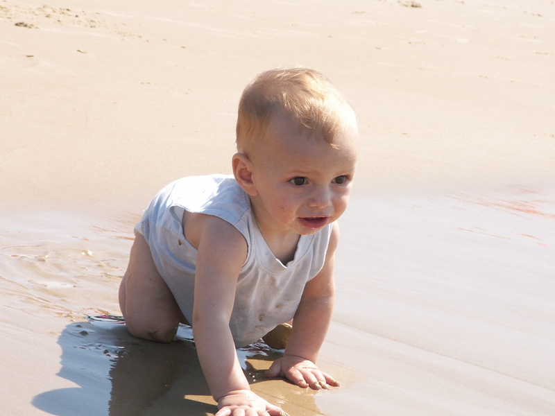 one person, looking at camera, sea, children only, family beach, beach, full length, shirt, boys, childhood, grey, cute, men, outdoors, sunlight, land