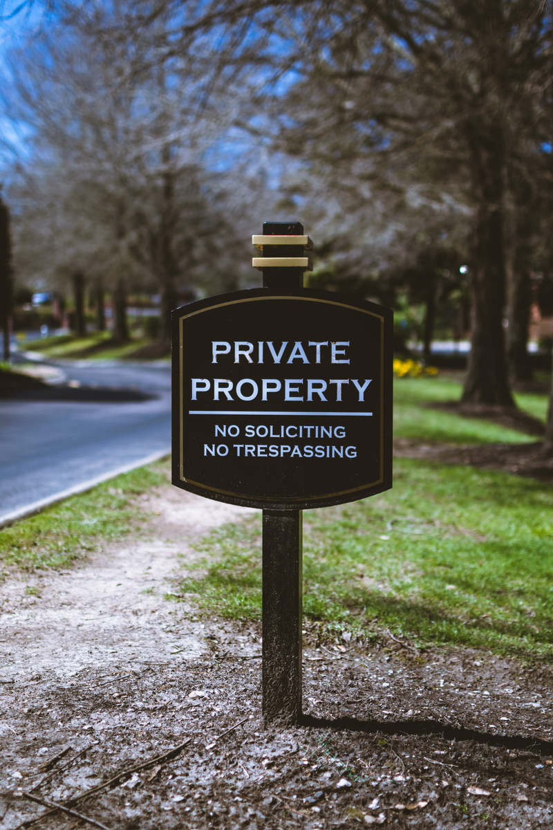 signage, western script, daylight, trees, communication, street, information sign, black, text, warning, park - man made space, warning sign, season, environment