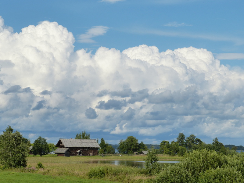 tree, environment, world heritage, clouds, historically, green color, plant, surrounded, built structure, beauty in nature, lake ladoga, cloud - sky, tourism