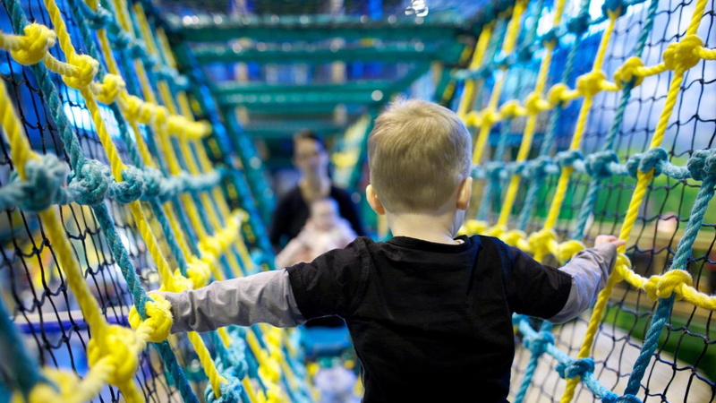 standing, smiling, indoors, innocence, cheerful, store, playground, three quarter length, shopping cart, aisle, black, grid, one Person, rear view, industry